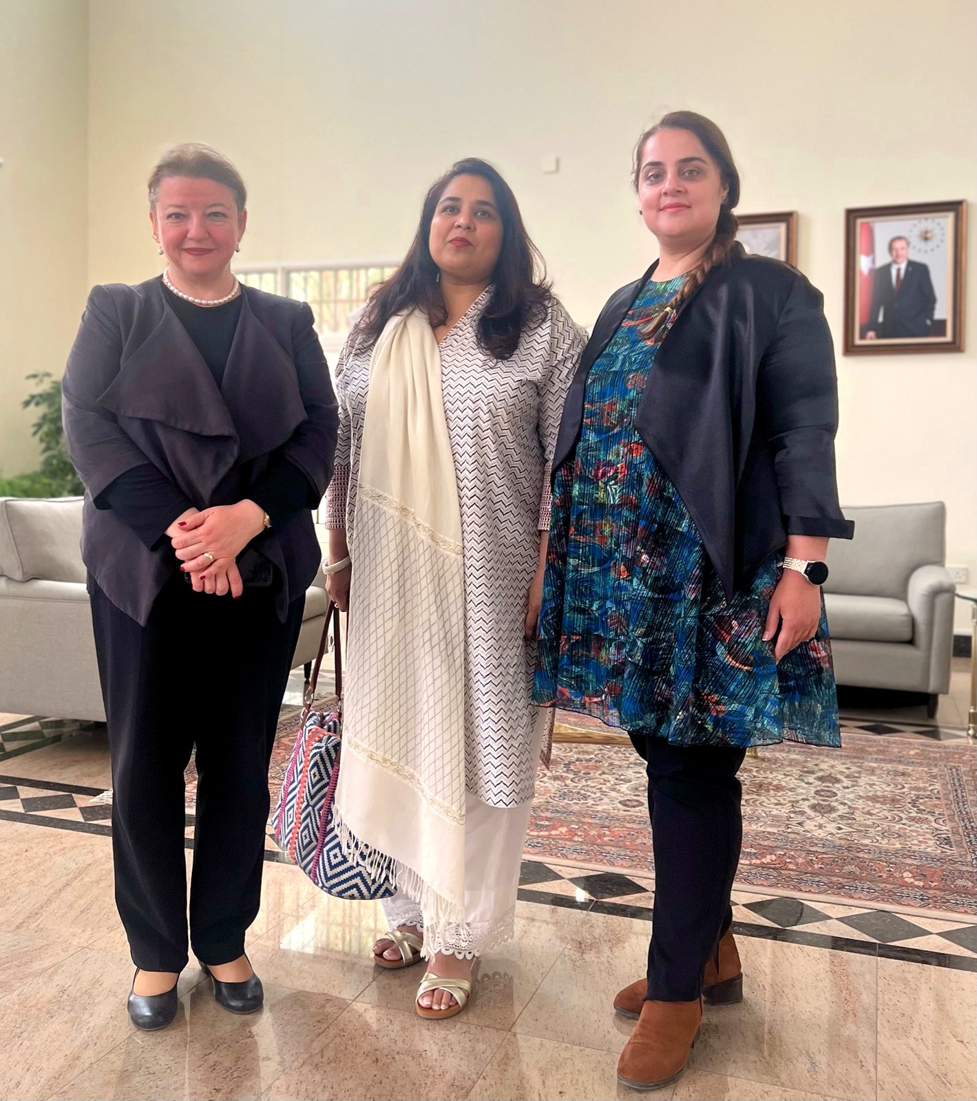 Shahmeen Islam with two women in a reception room
