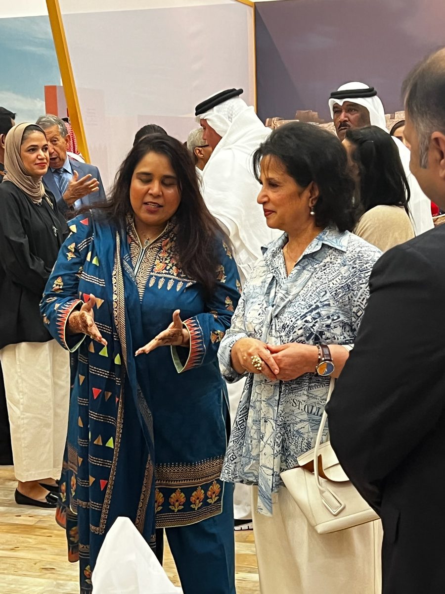 Shahmeen Islam talking with guests at an event