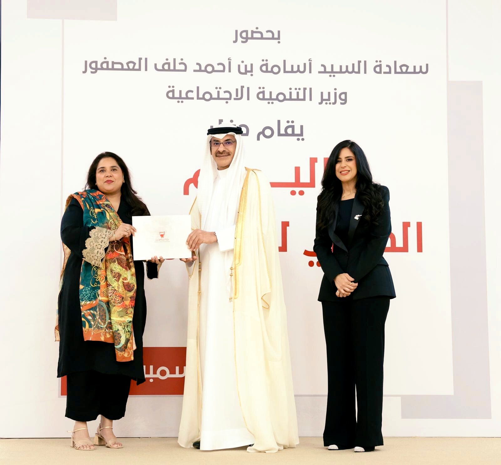 Shahmeen Islam receiving a certificate on stage