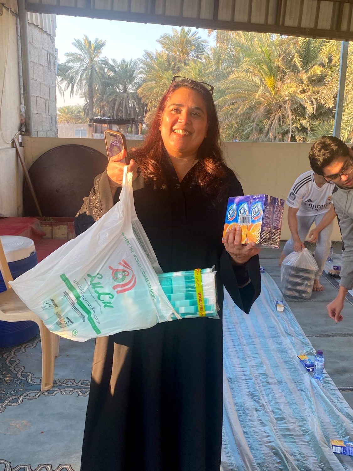 Shahmeen Islam holding donated supplies at a Ramadan drive