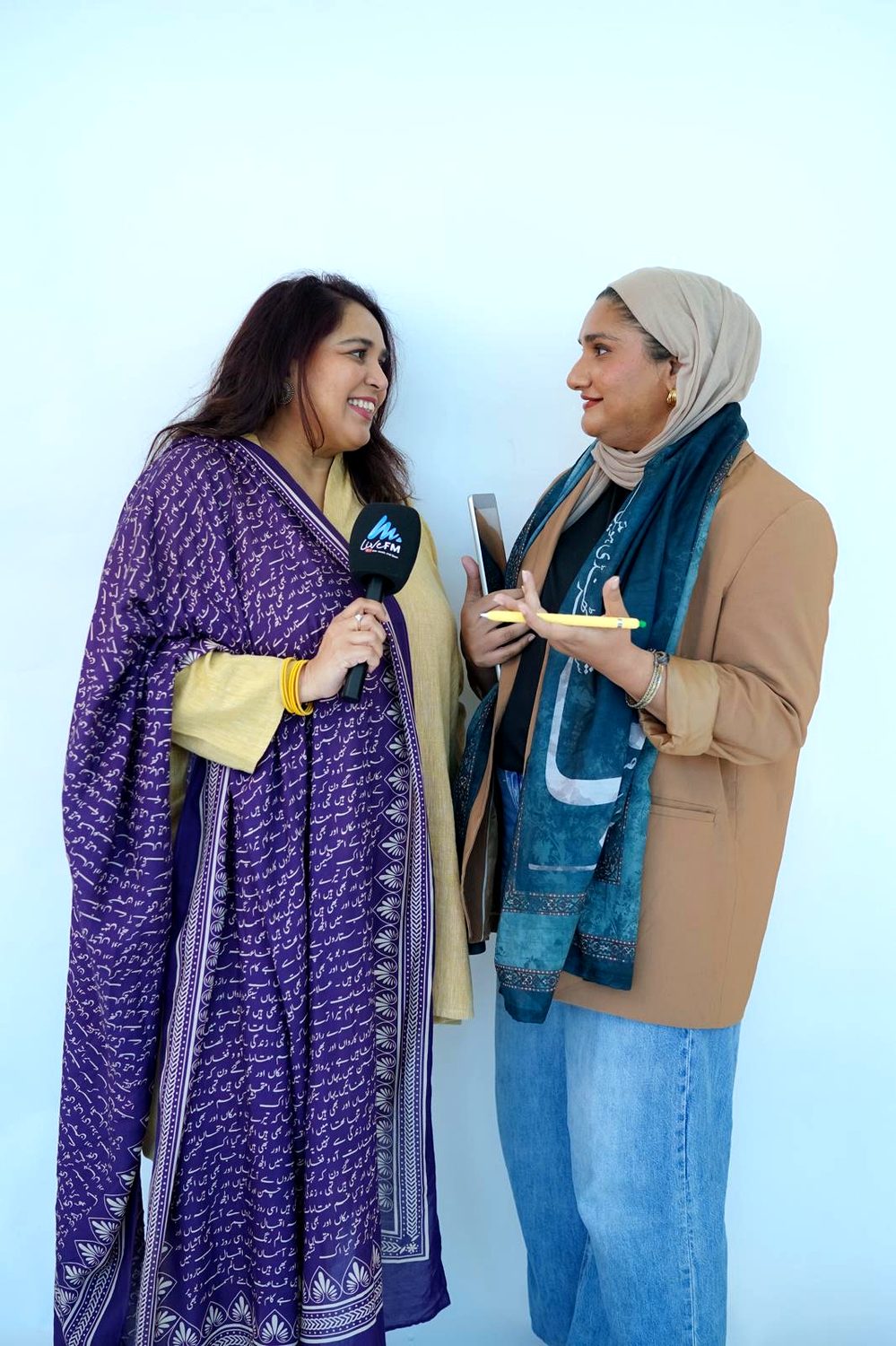 Shahmeen Islam holding a microphone, talking with her co-founder
