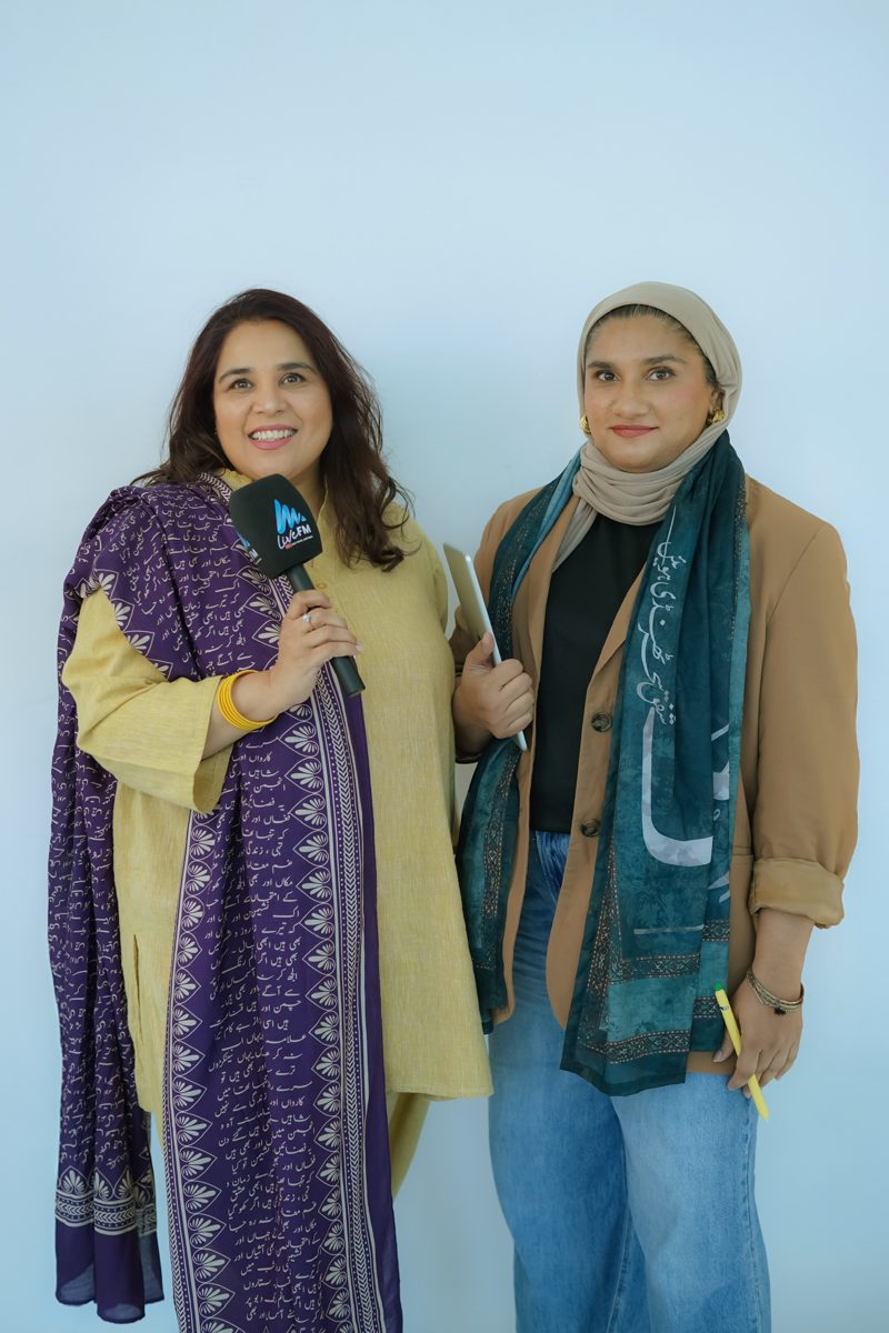 Shahmeen Islam and Saba holding a microphone