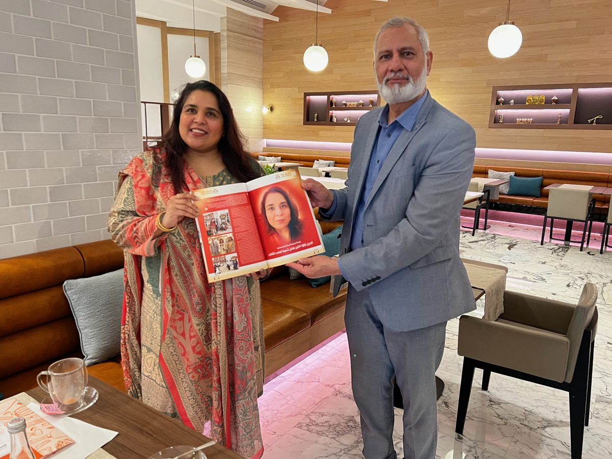 Shahmeen Islam holding open a printed feature about her