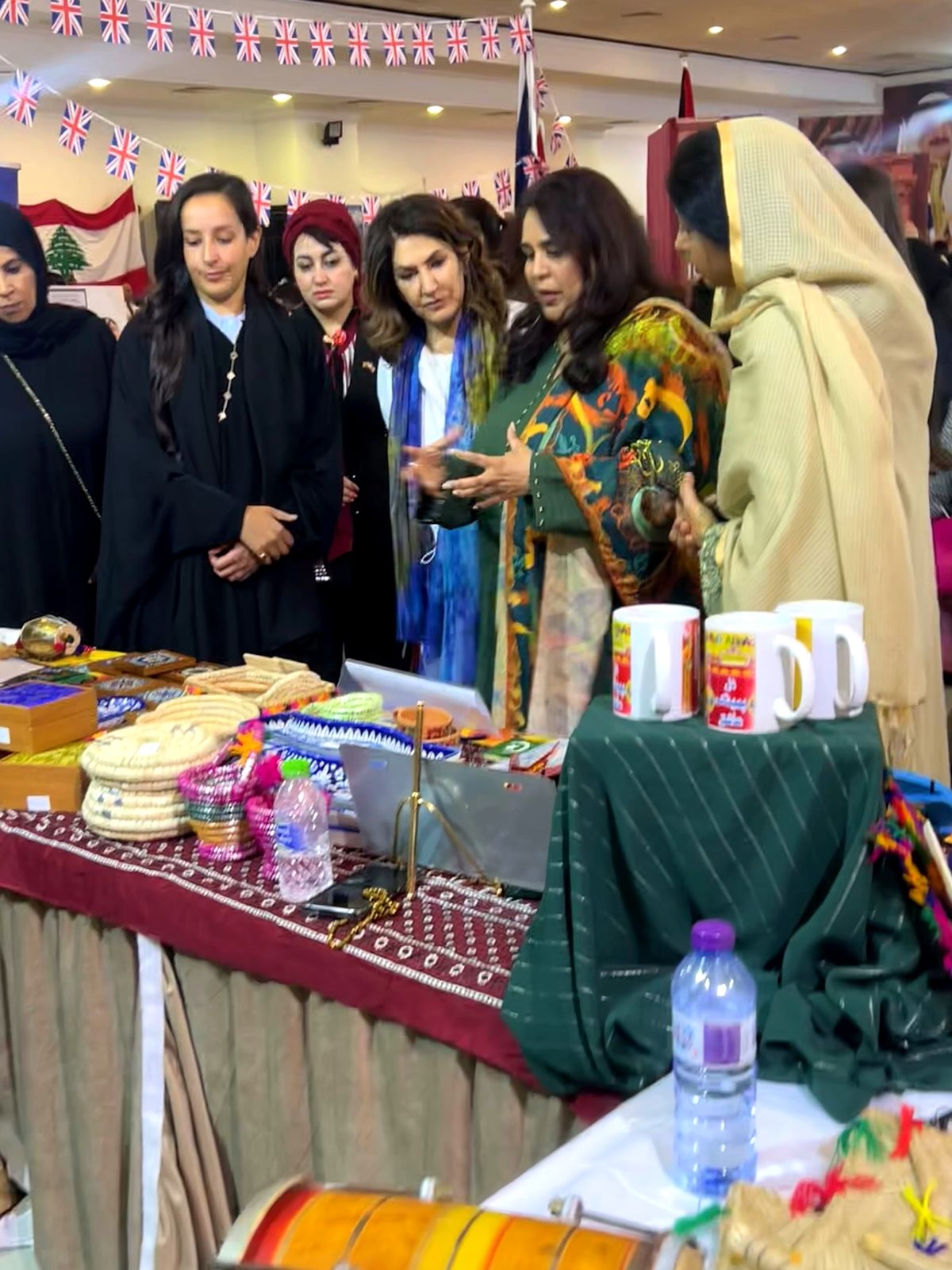 Shahmeen Islam showing handmade crafts to guests